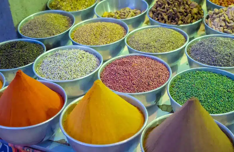 Colorful spices and herbs displayed in bowls at a traditional market in Aswan Egypt