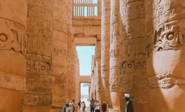 2 Days Luxor City Tours From Hurghada A-picture-of-some-visitors-near-the-columnzs -of-Karnak-Temple. A-picture-of-some-visitors-near-the-columns-of-Karnak-Temple