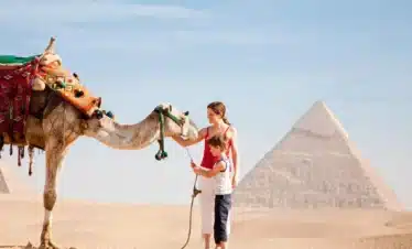 12 Day Egypt Highlights Cairo, Alexandria, Nile Cruise & Bahariya Oasis Wonderful-picture-of-a-little-boy-and-his-mother-with-a-camel-in-front-of-the-pyramids