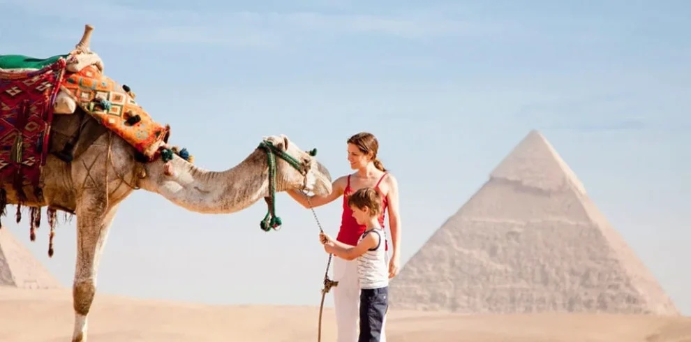 12 Day Egypt Highlights Cairo, Alexandria, Nile Cruise & Bahariya Oasis Wonderful-picture-of-a-little-boy-and-his-mother-with-a-camel-in-front-of-the-pyramids