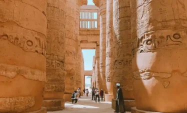 2 Days Luxor City Tours From Hurghada A-picture-of-some-visitors-near-the-columnzs -of-Karnak-Temple. A-picture-of-some-visitors-near-the-columns-of-Karnak-Temple