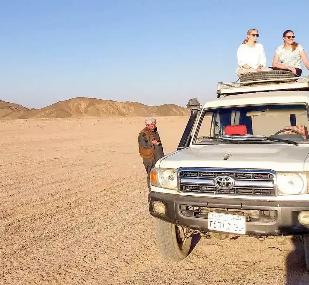 wonderful-shot-of-two-girls-sitting-on-a-four-wheel-drive-vehicle-from-a-safari-trip