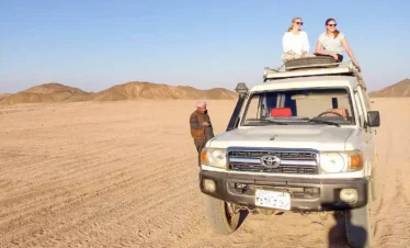 wonderful-shot-of-two-girls-sitting-on-a-four-wheel-drive-vehicle-from-a-safari-trip