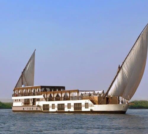 Yakouta Dahabiya sailing on the Nile River with traditional sails